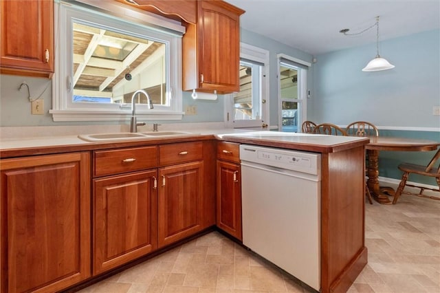 kitchen with hanging light fixtures, dishwasher, sink, and kitchen peninsula