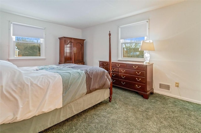 carpeted bedroom featuring multiple windows