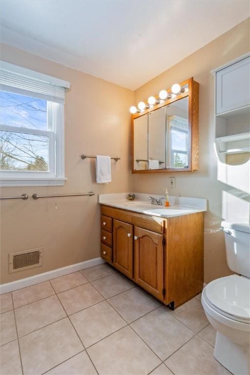 bathroom featuring vanity, toilet, and tile patterned flooring