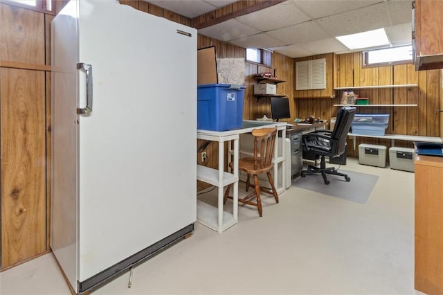 office area featuring a paneled ceiling and wooden walls