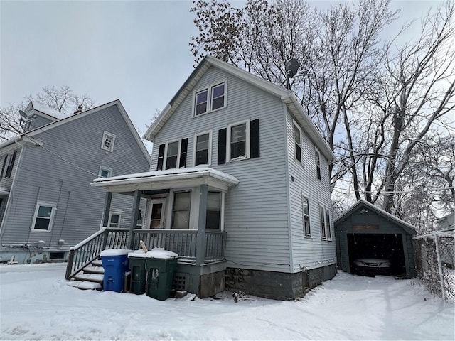 view of front of house with a garage, an outdoor structure, and a porch