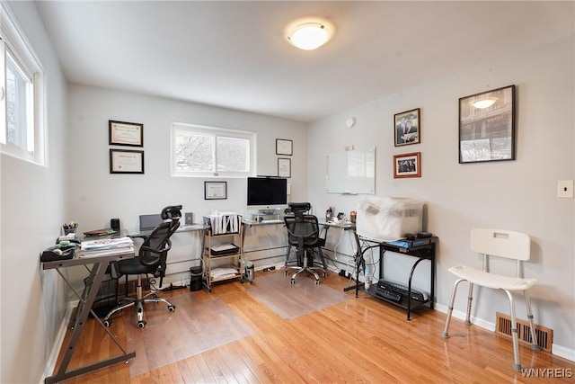 office space with hardwood / wood-style floors