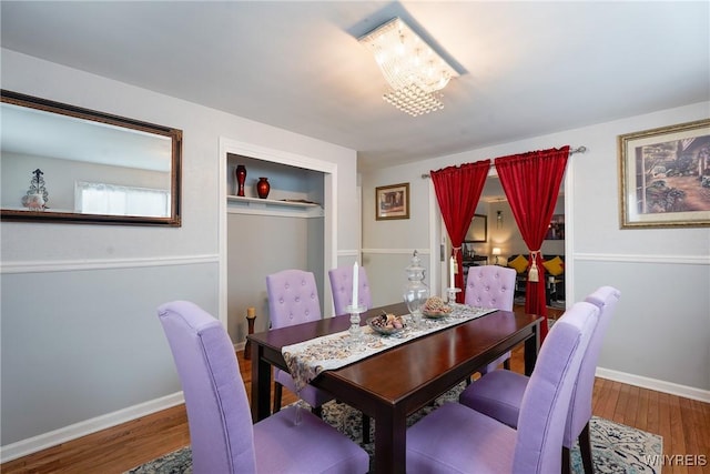 dining room featuring wood-type flooring and a chandelier