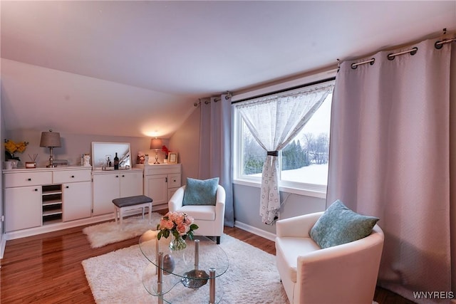 sitting room with lofted ceiling and light wood-type flooring