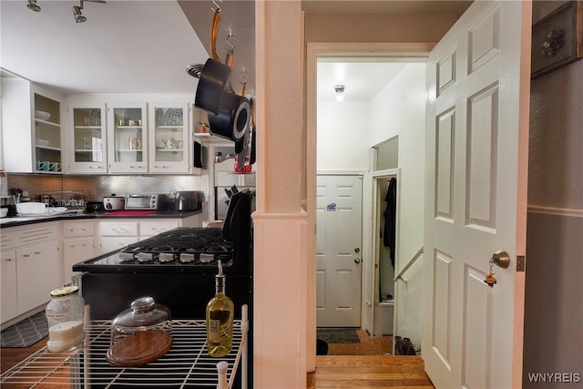 kitchen featuring tasteful backsplash, white cabinetry, and light wood-type flooring