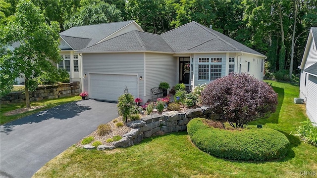 single story home with a garage and a front lawn