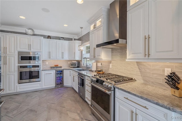 kitchen with stainless steel appliances, wall chimney range hood, crown molding, beverage cooler, and white cabinetry