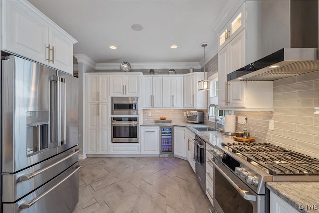 kitchen featuring appliances with stainless steel finishes, sink, white cabinetry, wine cooler, and wall chimney exhaust hood