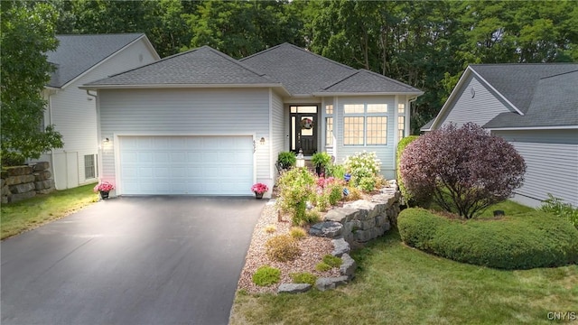 view of front of home with a garage and a front yard