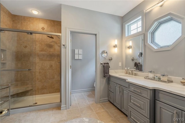 bathroom with tile patterned flooring, vanity, toilet, and walk in shower