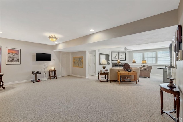 carpeted living room featuring ceiling fan