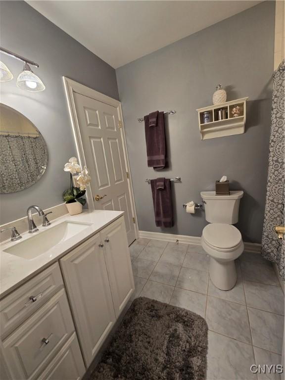 bathroom featuring tile patterned floors, toilet, and vanity