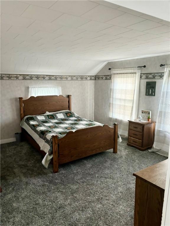 bedroom featuring vaulted ceiling and carpet