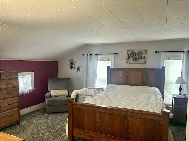 carpeted bedroom with lofted ceiling