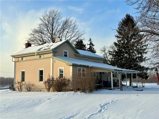 snow covered house with covered porch