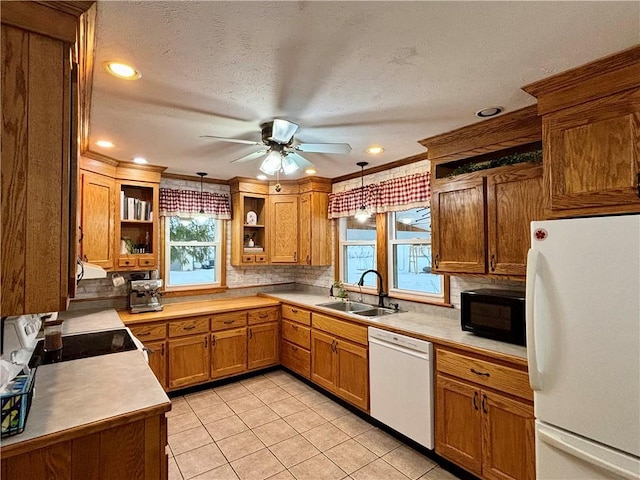 kitchen featuring light tile patterned flooring, decorative light fixtures, tasteful backsplash, sink, and white appliances