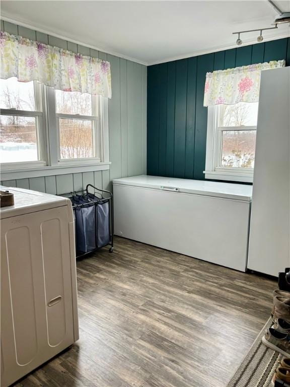 interior space with washer / dryer, wood-type flooring, and plenty of natural light