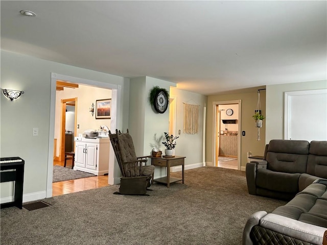 carpeted living room featuring sink