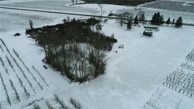 snowy aerial view featuring a rural view