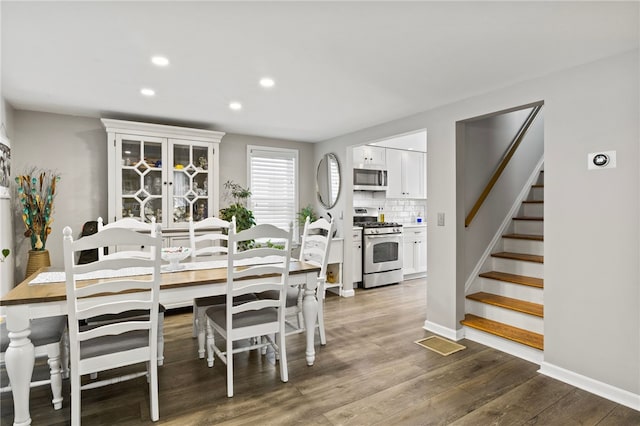 dining space featuring dark wood-type flooring