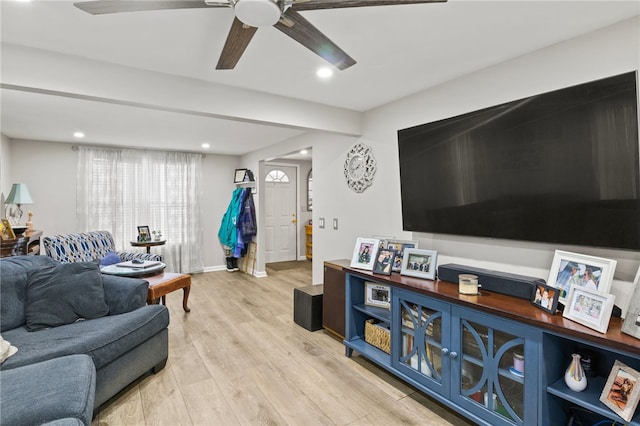 living room featuring ceiling fan and light hardwood / wood-style floors