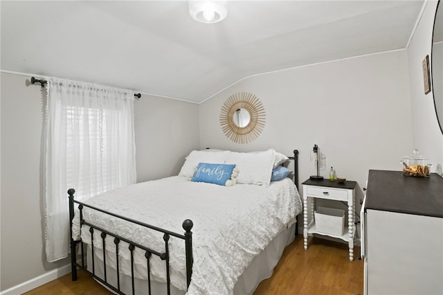 bedroom featuring lofted ceiling and hardwood / wood-style flooring