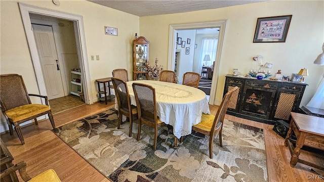 dining area with a fireplace and wood-type flooring