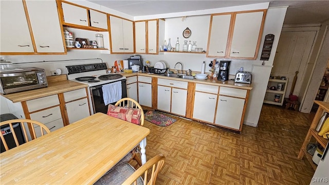 kitchen featuring white cabinetry, white electric range oven, sink, and light parquet floors