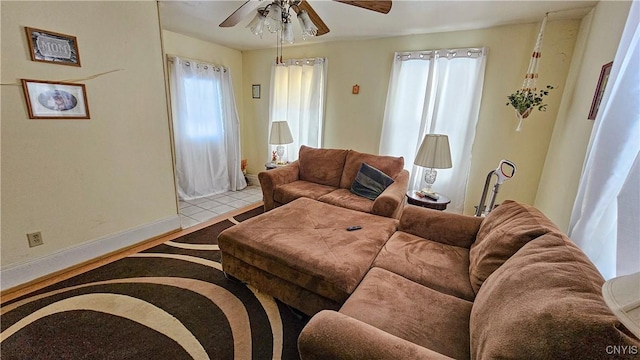 tiled living room featuring a wealth of natural light and ceiling fan