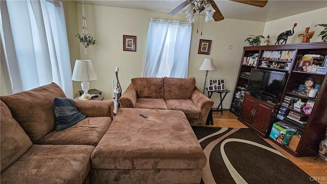 living room featuring hardwood / wood-style floors and ceiling fan