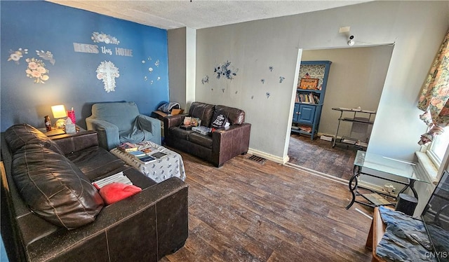 living room featuring dark hardwood / wood-style floors and a textured ceiling