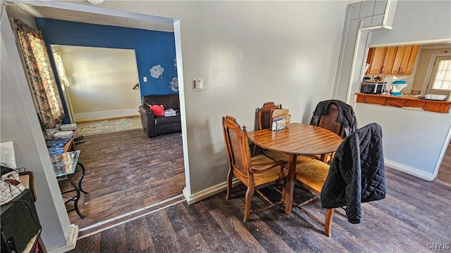 dining area featuring dark hardwood / wood-style flooring