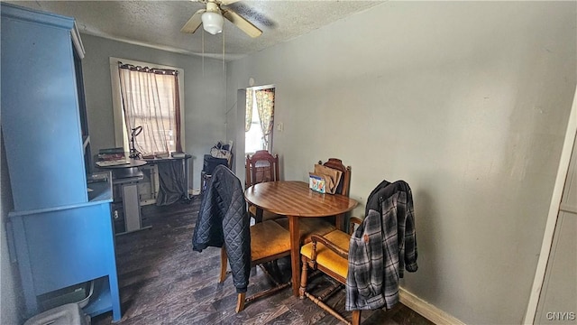 dining room with dark hardwood / wood-style flooring, a textured ceiling, and ceiling fan