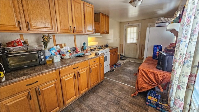 kitchen featuring white appliances and dark wood-type flooring