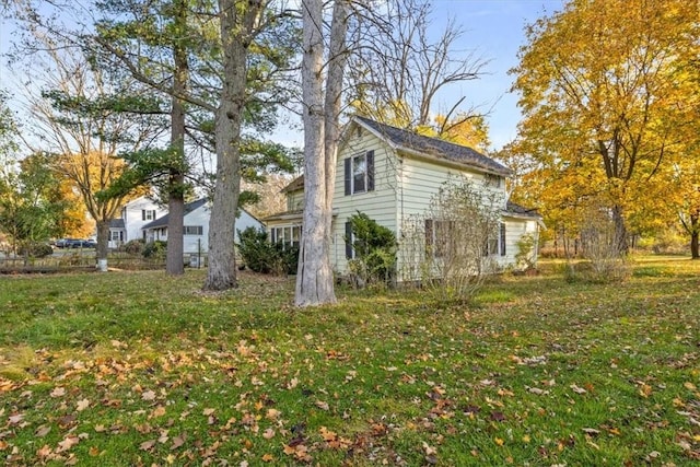 view of side of home with a lawn