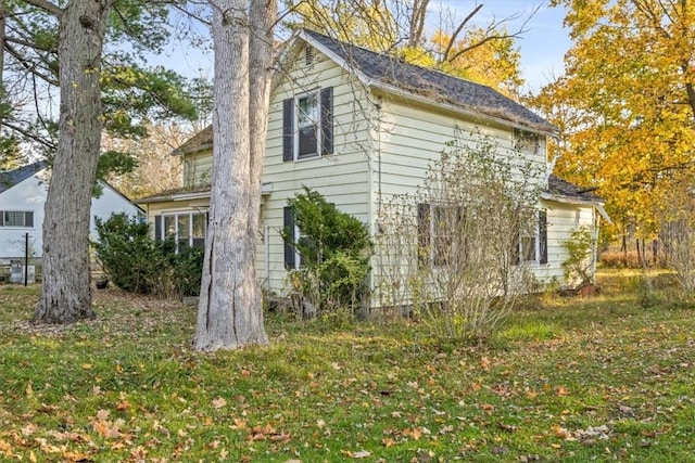 view of side of property with a lawn