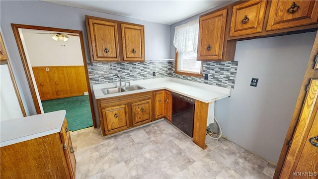 kitchen with black dishwasher, sink, and backsplash