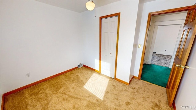 unfurnished bedroom with a closet and carpet flooring