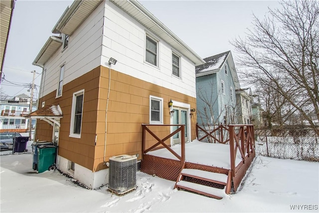 view of snowy exterior with central AC unit