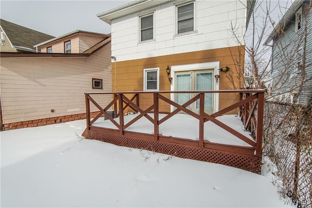 view of snow covered rear of property