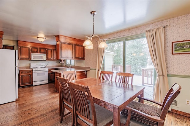 dining area featuring sink and hardwood / wood-style floors