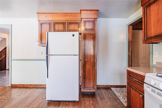 kitchen featuring white appliances and hardwood / wood-style flooring