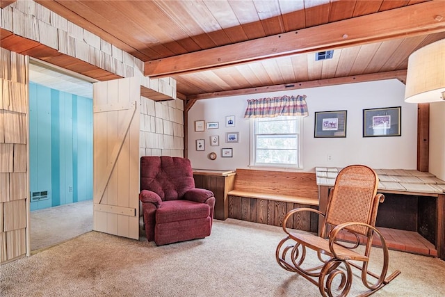 living area with beamed ceiling, light colored carpet, and wooden ceiling