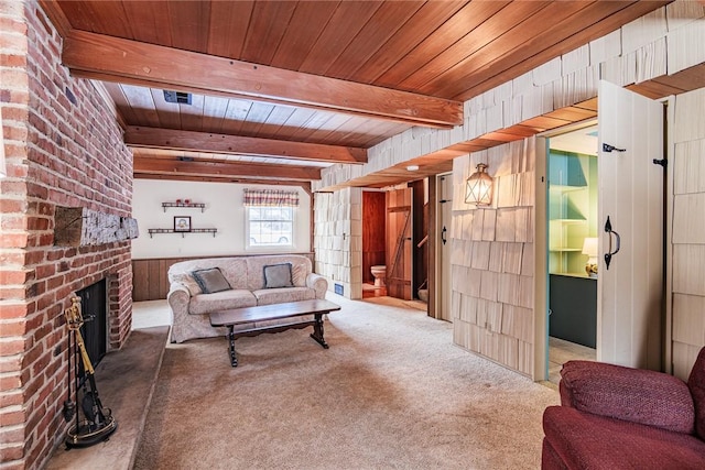 living room with beamed ceiling, carpet, wooden ceiling, and wooden walls