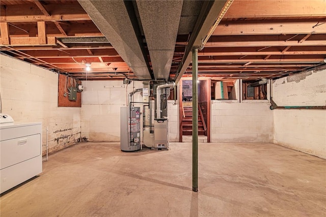 basement featuring water heater, washer / dryer, and heating unit