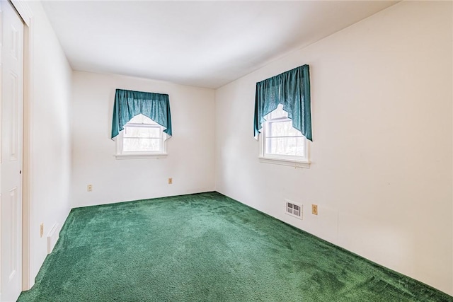 empty room featuring a healthy amount of sunlight and carpet floors