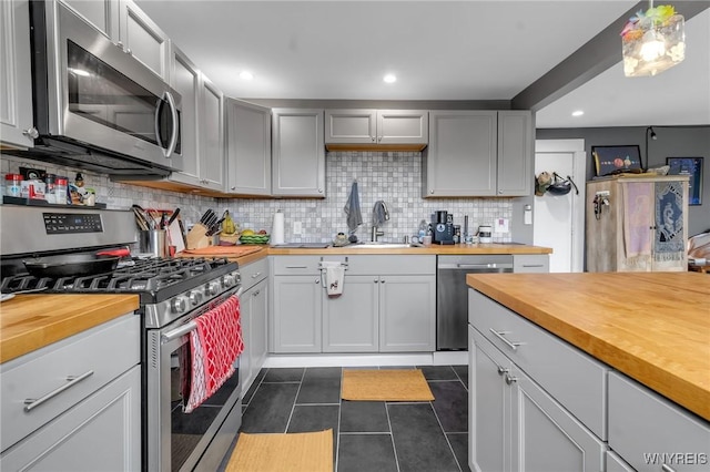 547 Potomac Ave, Buffalo, NY 14222 - kitchen featuring tasteful backsplash, appliances with stainless steel finishes, sink, and butcher block countertops