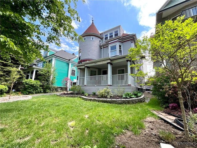 view of front of house featuring a front yard and covered porch