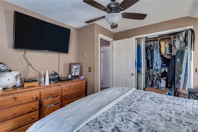 bedroom with ceiling fan, a closet, and a textured ceiling