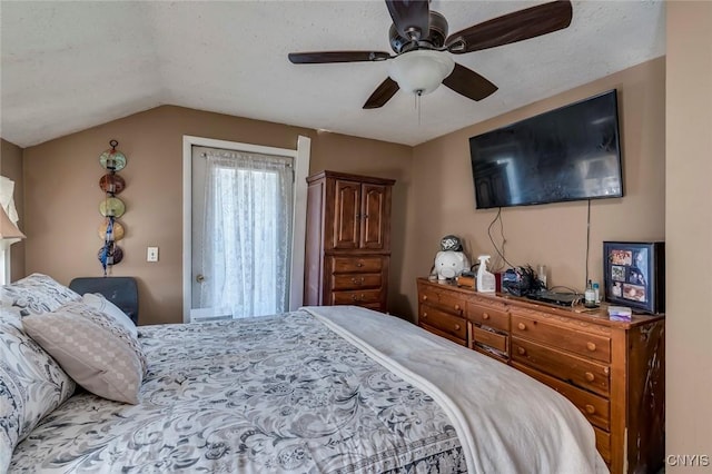 bedroom with vaulted ceiling, ceiling fan, and a textured ceiling